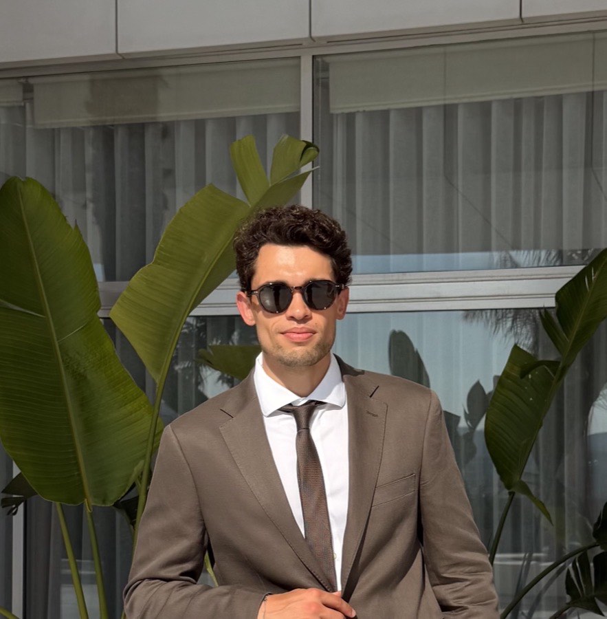 André Emiliano, Senior Developer, in a suit outdoors
